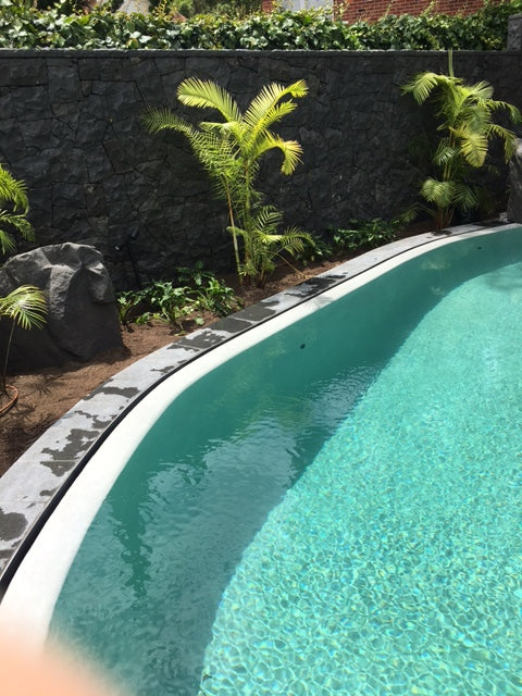 <p>Concrete pool with weir and waterfall</p>